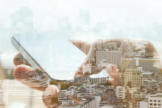 Double exposure of cityscape and smart phone, business technology concept.
