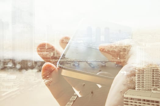 Double exposure of cityscape and smart phone, business technology concept.