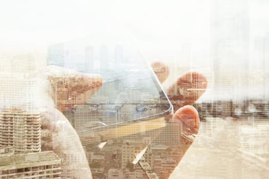 Double exposure of cityscape and smart phone, business technology concept.