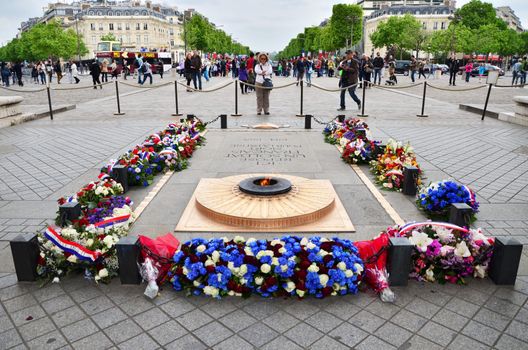 Paris, France - May 14, 2015: Tourist visit Tomb of the Unknown Soldier beneath the Arc de Triomphe, Paris. on May 14, 2015.