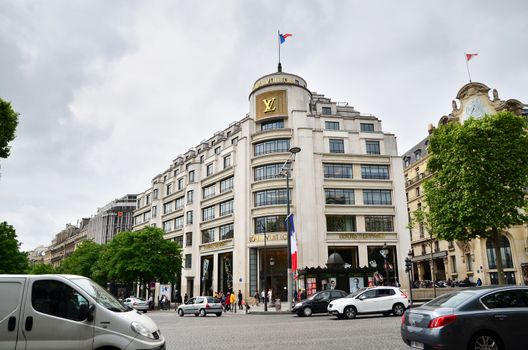 Paris, France - May 14, 2015: Tourists Shopping at Louis Vuitton store on May 14, 2015 in Paris, France. This store is located on the Champs Elyses and offers a wide range of luxury Louis Vuitton clothes and accessories