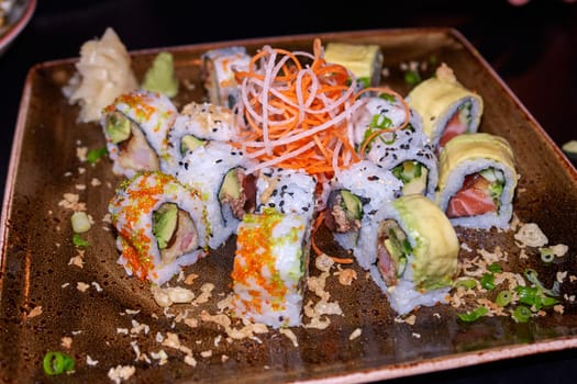 Sushi typical Japanese food served on a plate in a restaurant                              