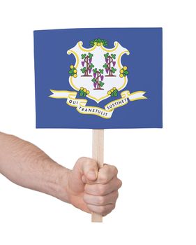 Hand holding small card, isolated on white - Flag of Connecticut