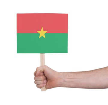 Hand holding small card, isolated on white - Flag of Burkina Faso