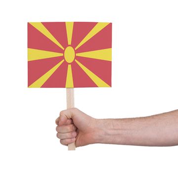 Hand holding small card, isolated on white - Flag of Macedonia