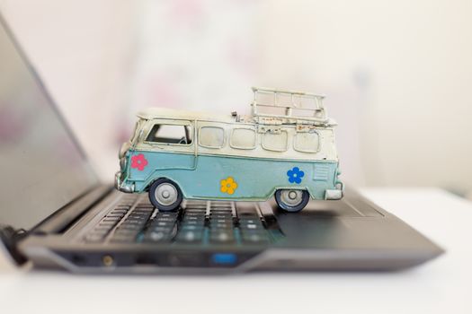 Close up detailed view of a black laptop pc with a colorful toy bus on.