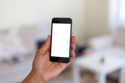Close up detailed view of a smart phone holding on hand, with white blank copy space screen.