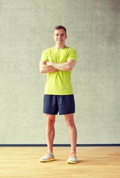 sport, fitness, lifestyle and people concept - smiling man in gym