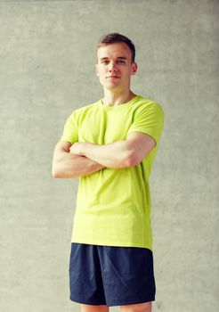 sport, fitness, lifestyle and people concept - smiling man in gym