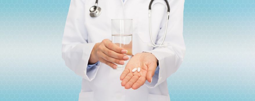 healthcare, medicine, people and pharmacy concept - close up of doctor with stethoscope offering pills and water over blue background