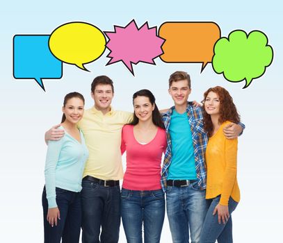 friendship, communication and people concept - group of smiling teenagers over white background with text bubbles