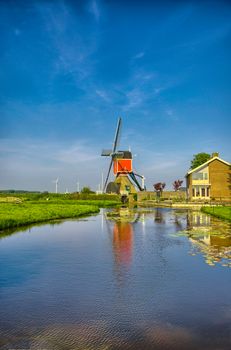 Windmills and water canal in Kinderdijk, Holland or Netherlands. Unesco world heritage site. Europe. HDR