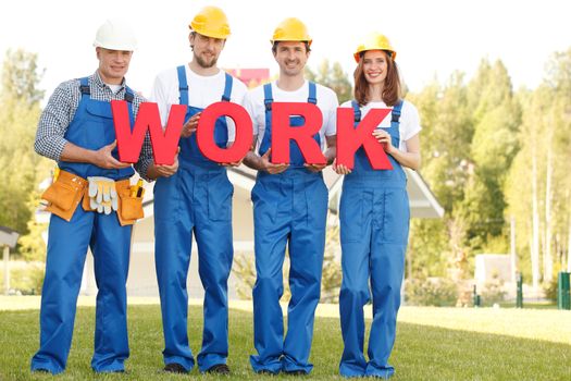 Group of workmen with word work outdoors