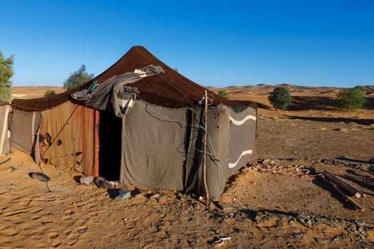 Berber tent in the Sahara desert on a background of blue sky, Morocco