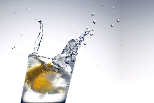 Lemon water and ice cubes isolated on white background