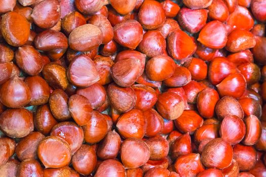 Pile of chestnuts. Autumn background.