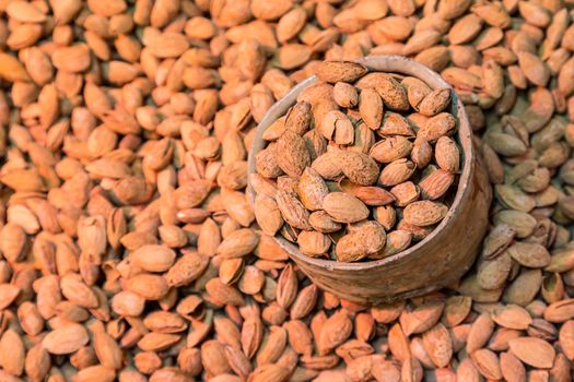 Scoop of almonds beeing sold on local food market.