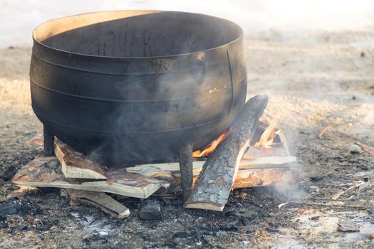 Black kettle on fire pit.