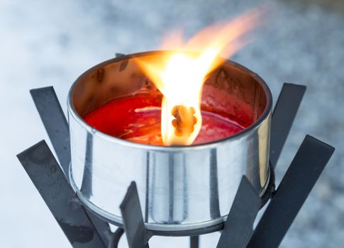 Light Burning in Metal Can close up.