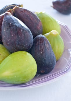 Group of green figs and blacks on a plate, italy