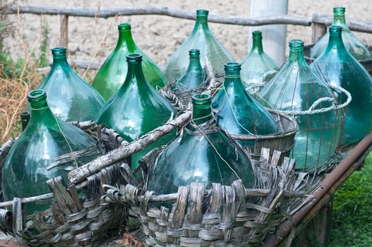 Empty bottles of wine on old wagon, italy