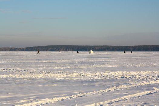 Fishermans on ice for fishing with equipments