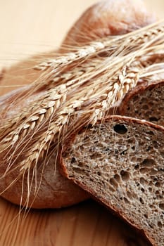 Farm still life. Freshness bread set and wheat ears on wooden board