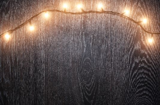 Christmas light on a brown hardwood. Horizontal photo