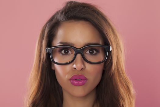 Beautiful casual woman over a pink background.