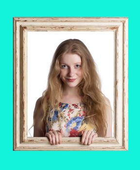 Abstract image of a beautiful woman trapped in a picture frame over a blue background.