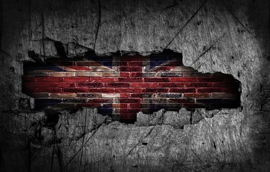 Broken grunge wall with British flag on old brick wall behind.