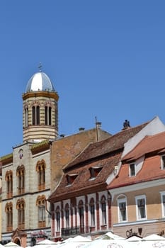 Churches, gates, towers, walls, buildings and ancient streets in downtown Brasov. Old windows, plaster slab, archways, green tourists