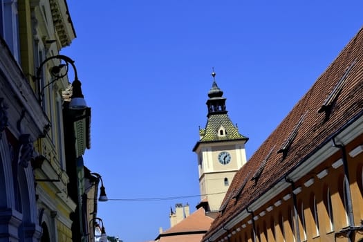 Churches, gates, towers, walls, buildings and ancient streets in downtown Brasov. Old windows, plaster slab, archways green, tourists