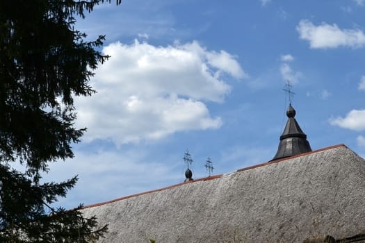 Old church roof fir.
The church is in a mountain village.
Blue skies rests on the church dome