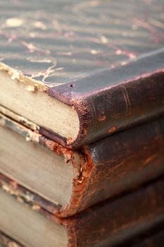 Extreme closeup of stack of few very old books as background