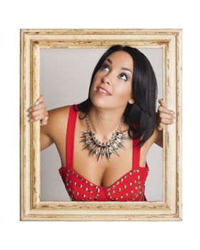 Abstract image of a beautiful woman trapped in a picture frame and making funny faces.