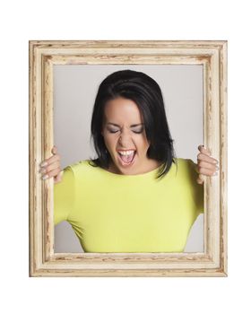 Abstract image of a beautiful woman trapped in a picture frame and making funny faces.