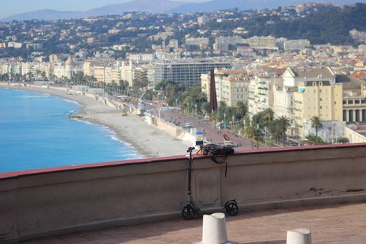 Scooter Leaning against a Wall. Aerial View of Nice in the Background