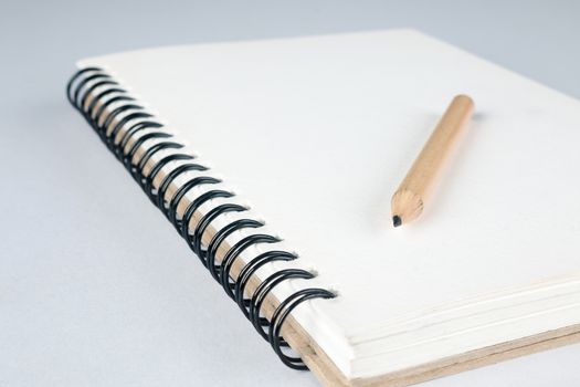 sketch book with pencil on white background