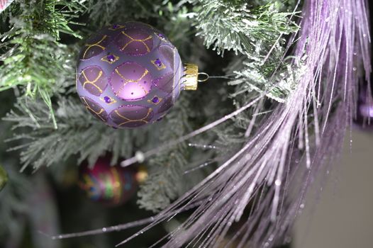 Background with snowy fur tree branch and Christmas balls.