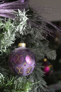 Background with snowy fur tree branch and Christmas balls.