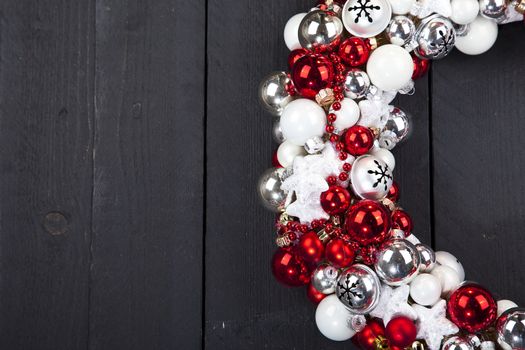 Christmas wreath with bells on dark wooden background