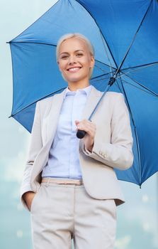 business, bad weather and people and concept - young smiling businesswoman with umbrella outdoors