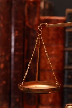 Closeup of old brass weight scales on cover books background