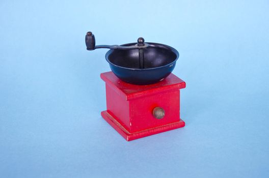 Spice grinder on blue background  