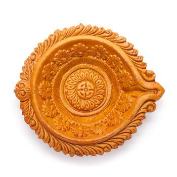 Top view of a beautifully carved designer handmade clay lamp isolated on white background.