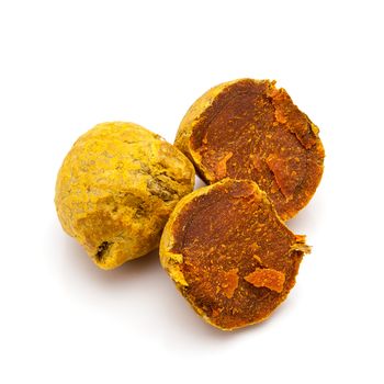 Macro closeup of a full and a cracked Organic Round Turmeric or Haldi (Curcuma longa) isolated on white background.