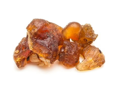 Macro closeup of a Organic Indian bdellium or Guggul resin (Commiphora wightii) isolated on white background.