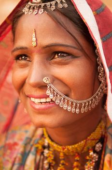 Portrait of Traditional Indian woman in sari costume covered her head with veil, India