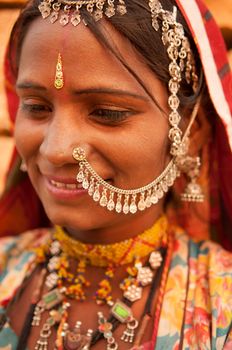 Portrait of beautiful traditional Indian woman in sari costume covered her head with veil, India people